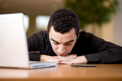 Man in office with head down