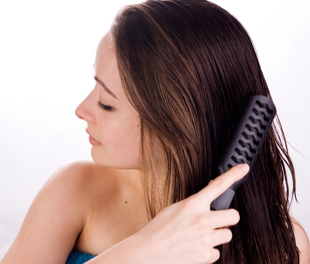 Woman is grooming her hair